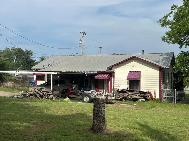 a front view of house with a garden and plants