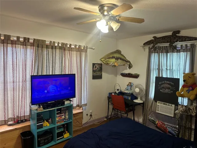 a view of a room with furniture and wooden floor