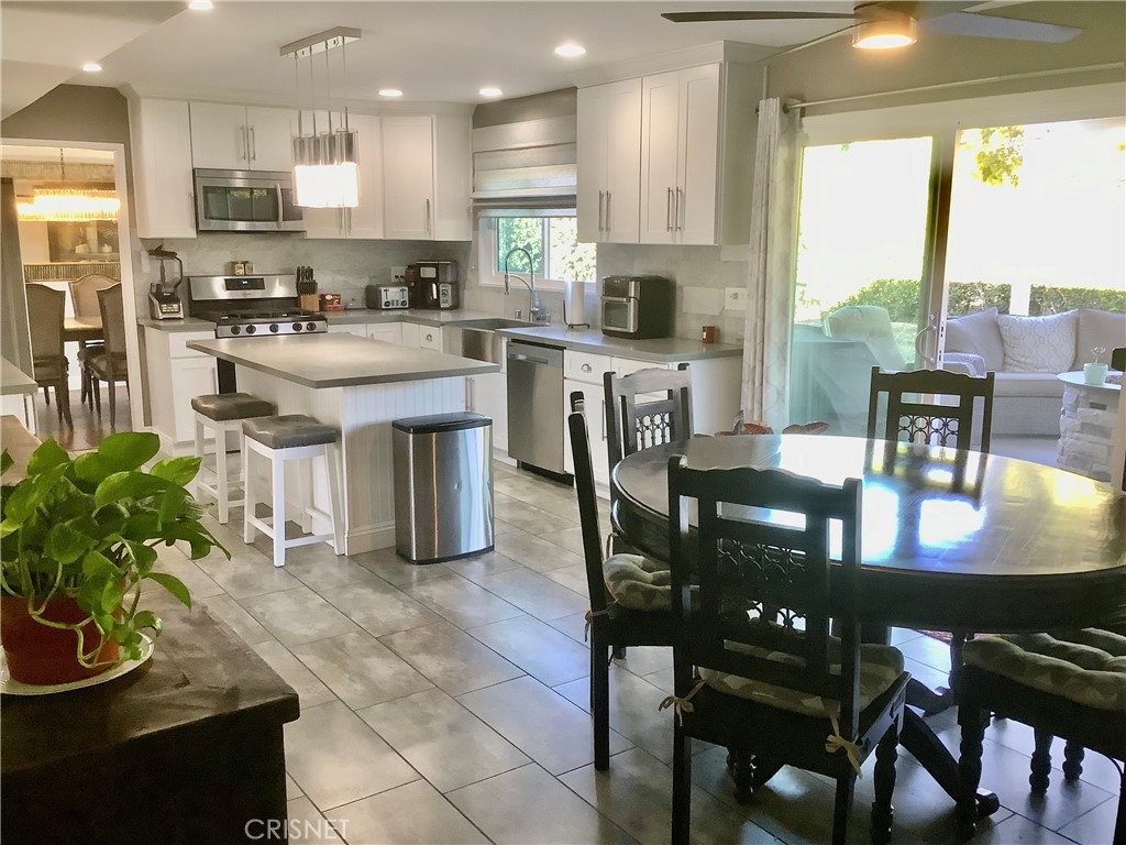 2163 Cheam Avenue Simi Valley, CA 93063 - Photo 14 of 43 a kitchen with stainless steel appliances granite countertop table chairs stove and refrigerator