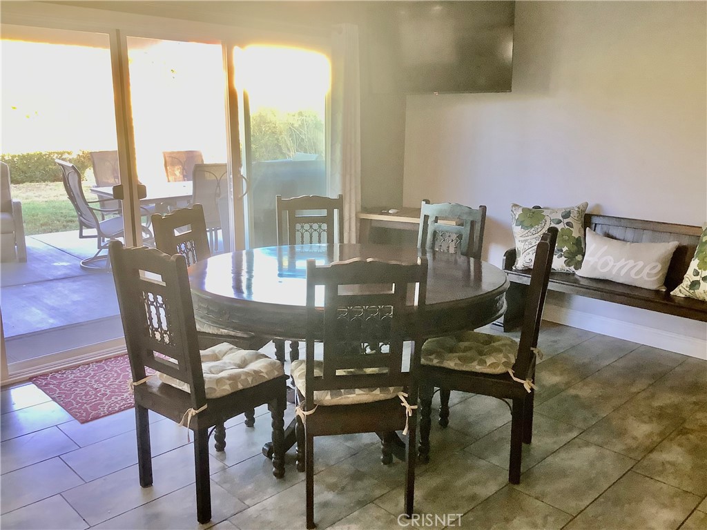 2163 Cheam Avenue Simi Valley, CA 93063 - Photo 19 of 43 a view of a dining room with furniture and wooden floor