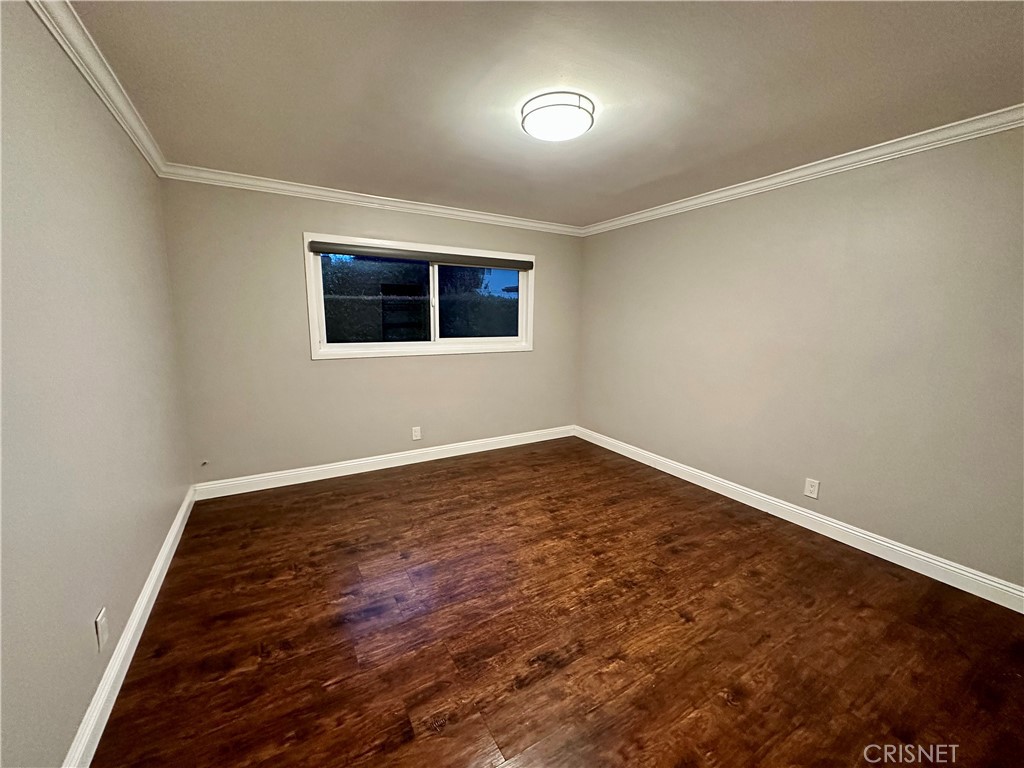 2163 Cheam Avenue Simi Valley, CA 93063 - Photo 21 of 43 a view of an empty room with wooden floor and a window