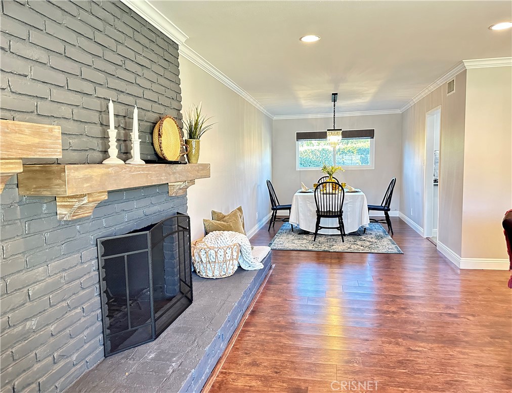 2163 Cheam Avenue Simi Valley, CA 93063 - Photo 3 of 43 a kitchen with furniture wooden floor and a fireplace