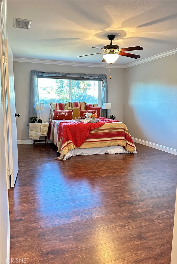 2163 Cheam Avenue Simi Valley, CA 93063 - Photo 7 of 43 a bedroom with a bed and a chandelier