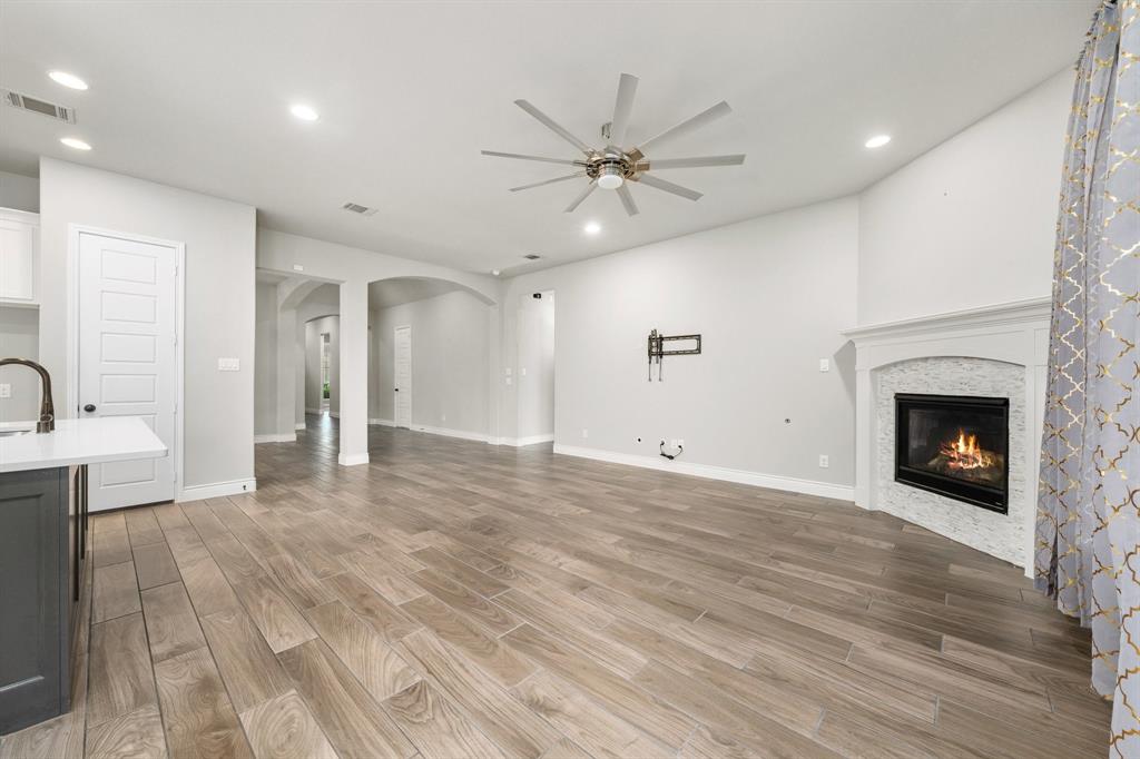 1501 Calcot Lane Forney, TX 75126 - Photo 10 of 34 Open concept living area featuring wood-finish flooring, recessed lighting, and a ceiling fan