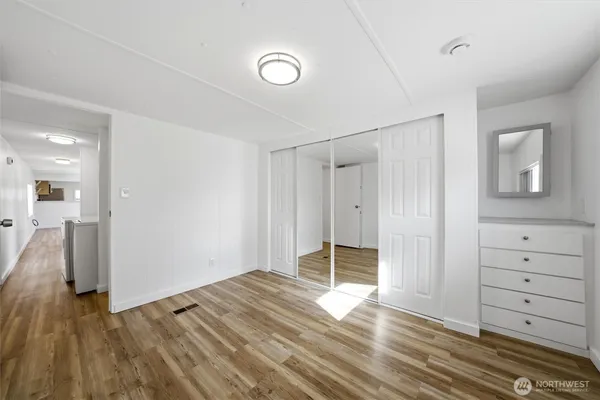 a view of empty room with wooden floor