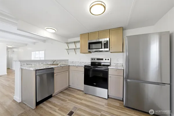 a kitchen with a refrigerator stove and sink