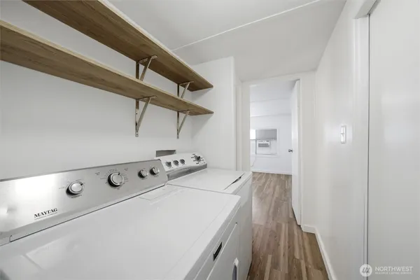 a view of washer and dryer with kitchen in the background