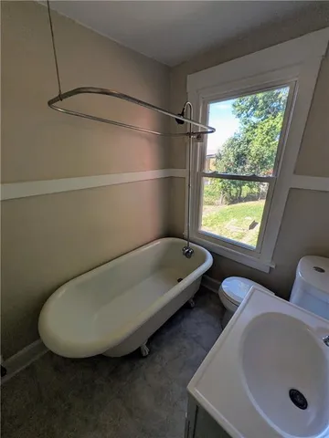 a bathroom with a tub and a window