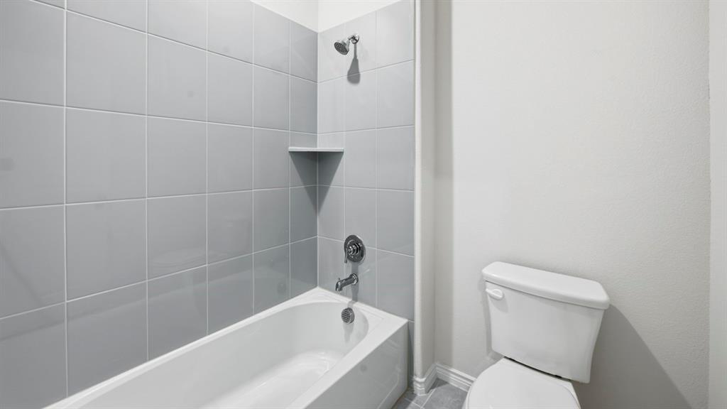 2104 Eugene Street Anna, TX 75409 - Photo 1 of 37 a white toilet sitting next to a bath tub