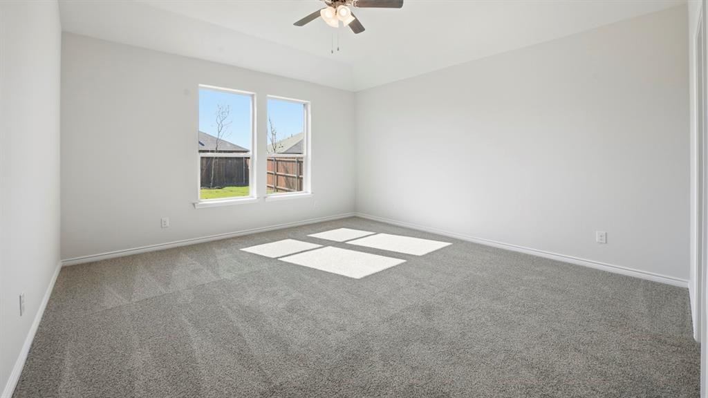 2104 Eugene Street Anna, TX 75409 - Photo 14 of 37 an empty room with a window and a ceiling fan