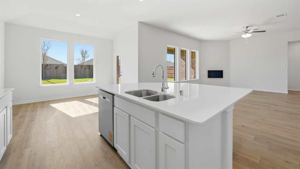 2104 Eugene Street Anna, TX 75409 - Photo 18 of 37 a kitchen with a sink a stove and cabinets
