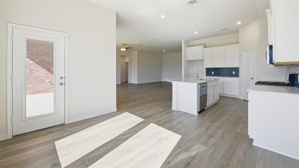 2104 Eugene Street Anna, TX 75409 - Photo 24 of 37 a view of a kitchen with wooden floor and electronic appliances