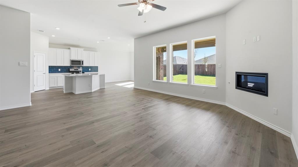 2104 Eugene Street Anna, TX 75409 - Photo 32 of 37 a view of an empty room with a window and wooden floor