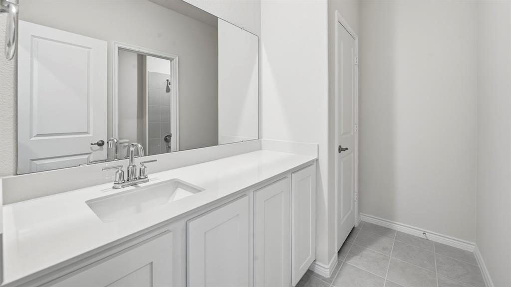 2104 Eugene Street Anna, TX 75409 - Photo 4 of 37 a bathroom with a sink and a mirror