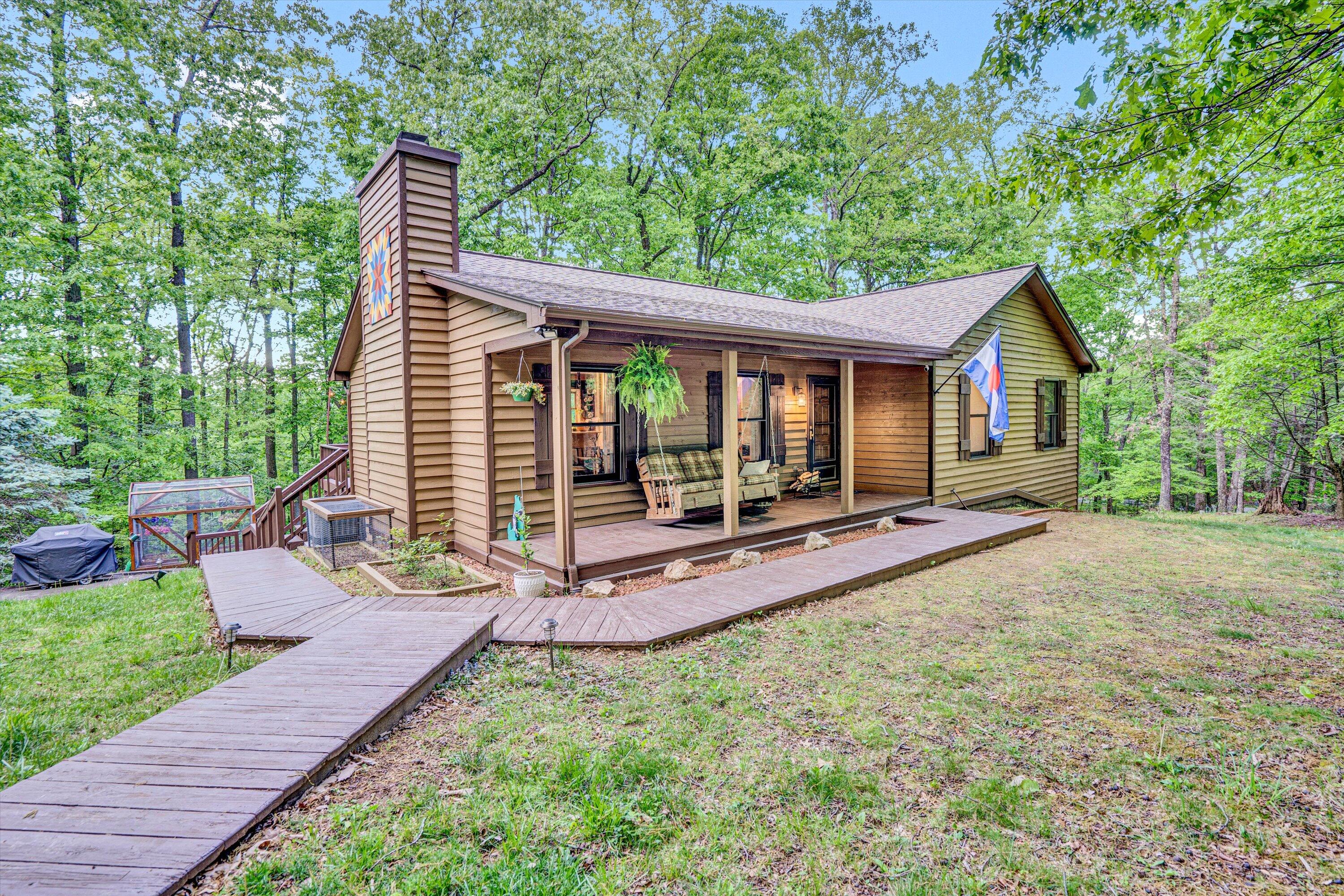 1033 Hickory Falls Road Blue Ridge, VA 24064 - Photo 1 of 52 a view of a house with backyard and sitting area