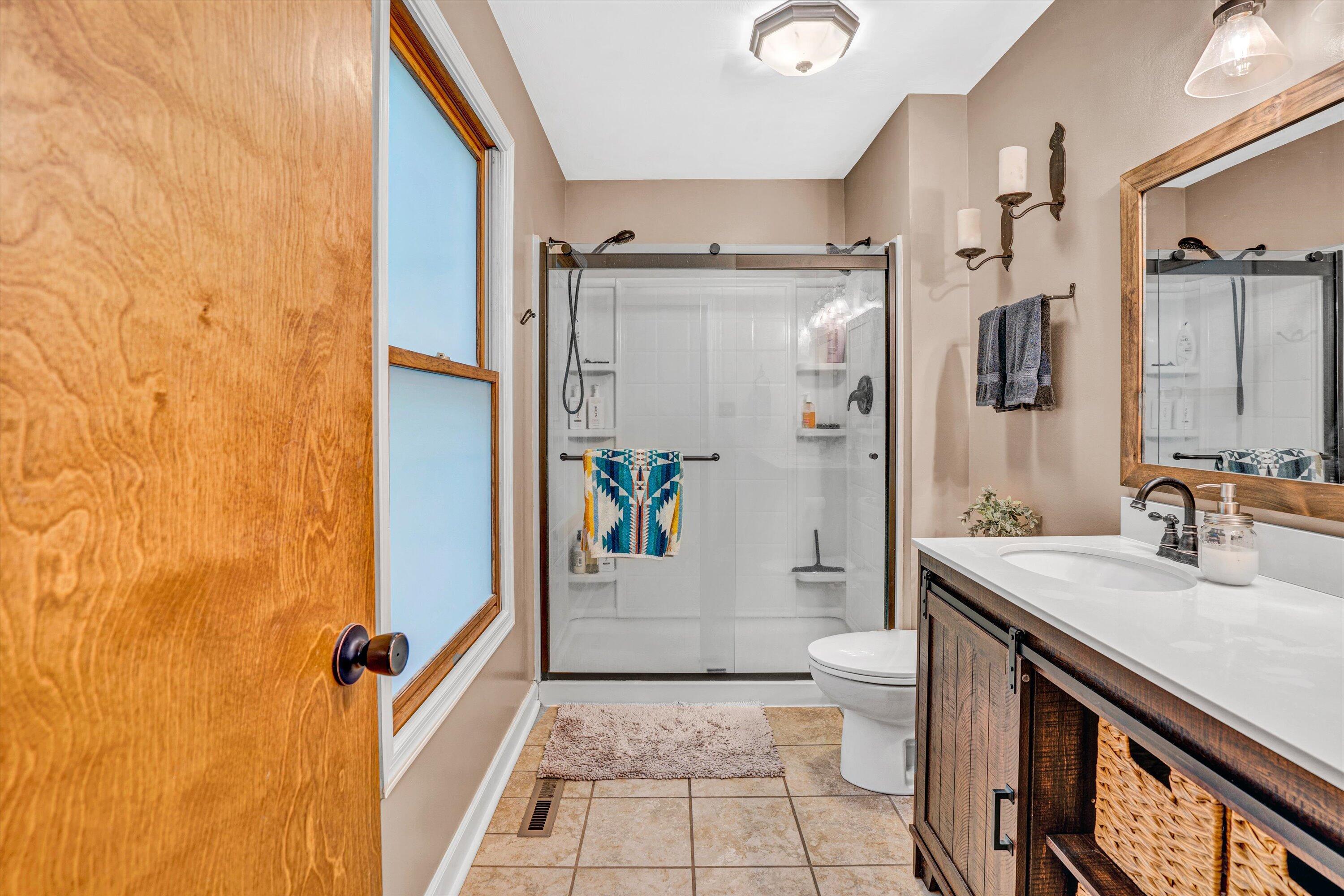1033 Hickory Falls Road Blue Ridge, VA 24064 - Photo 26 of 52 a bathroom with a sink a toilet and shower
