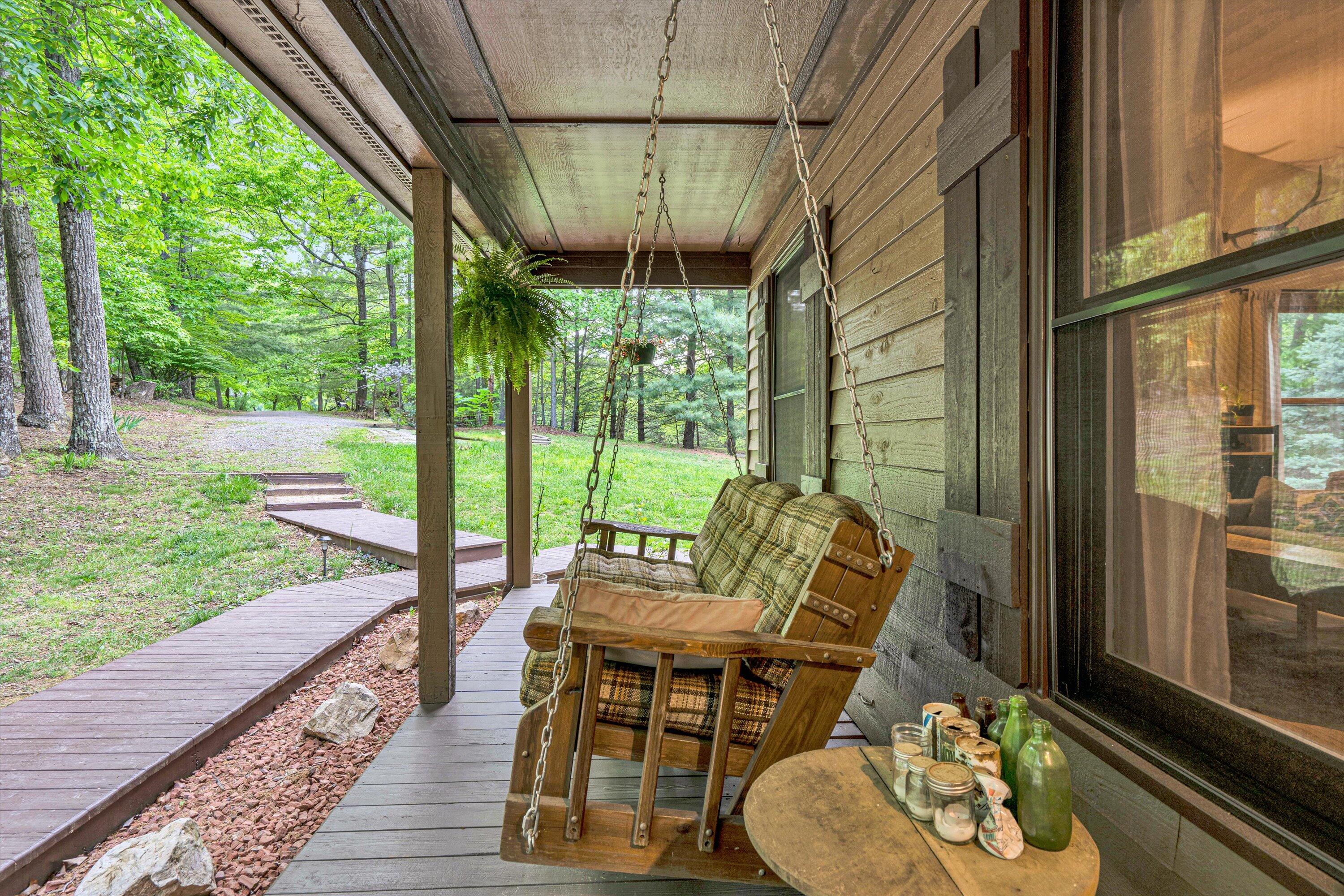 1033 Hickory Falls Road Blue Ridge, VA 24064 - Photo 3 of 52 a view of a porch with furniture and a yard