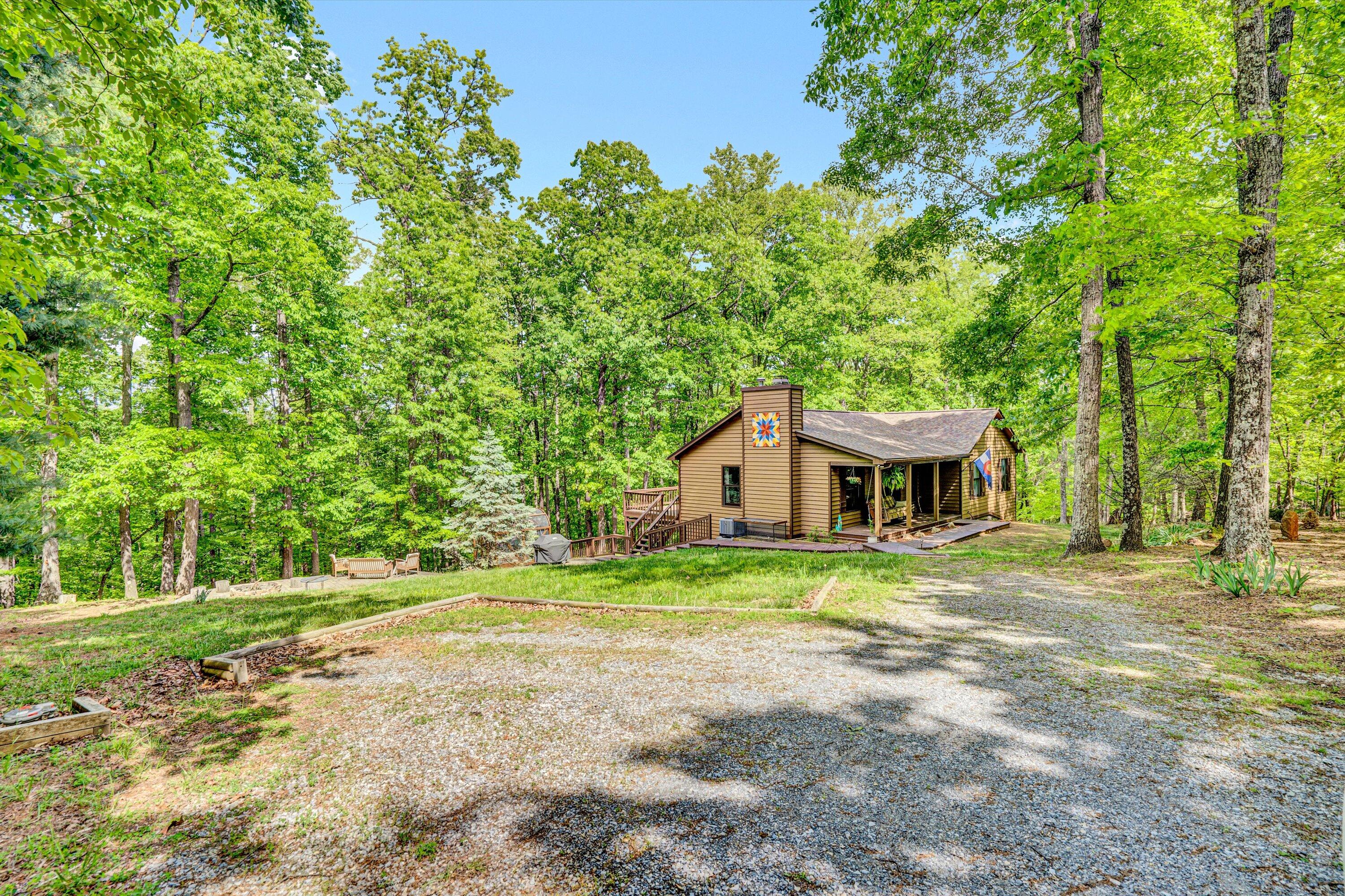 1033 Hickory Falls Road Blue Ridge, VA 24064 - Photo 51 of 52 a view of a house with a yard and large trees