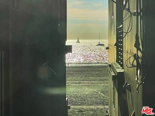 a bed sitting in a bedroom next to a blue wall