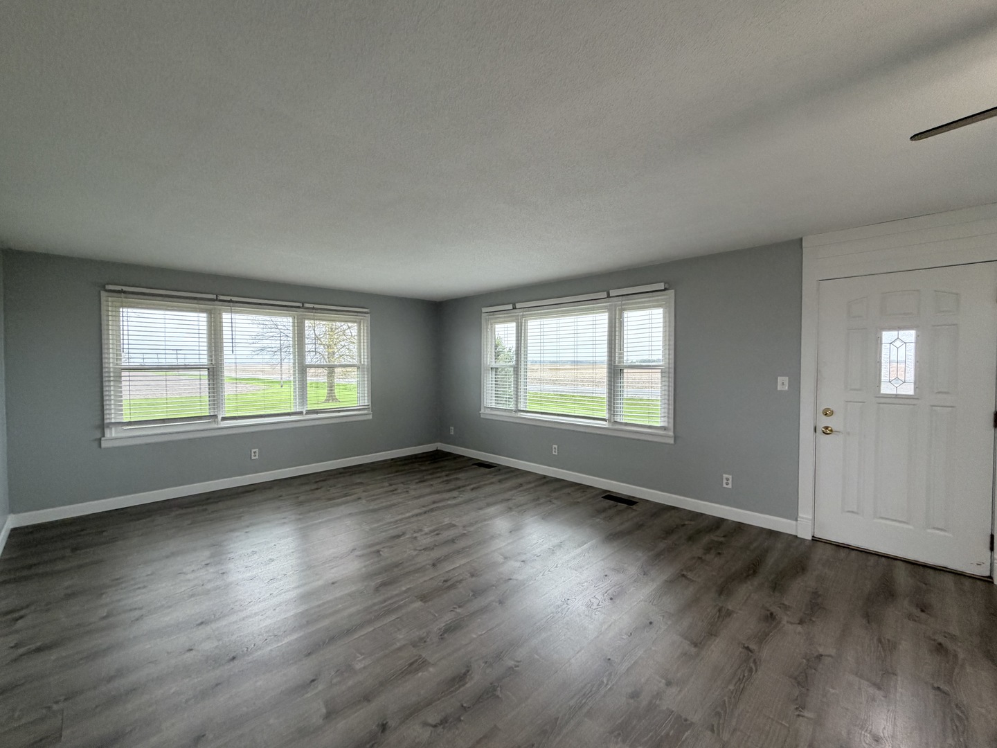 15266 LeRoy Road Farmer City, IL 61842 - Photo 8 of 36 an empty room with wooden floor and windows