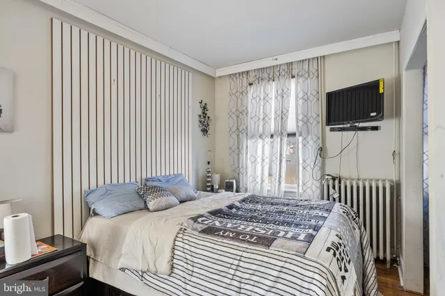 a bedroom with furniture and a window