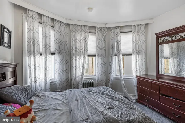 a bedroom with a bed and a couch