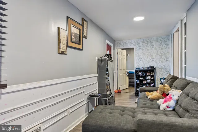 a living room with furniture chess board and a couch