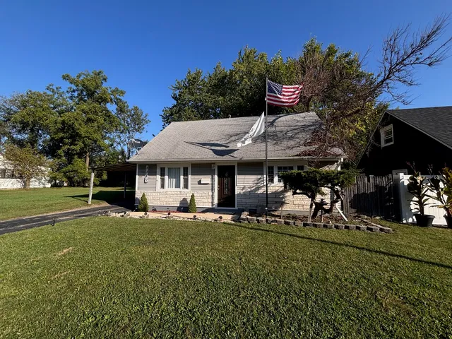 a view of a house with a yard porch and sitting area