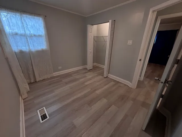 an empty room with wooden floor