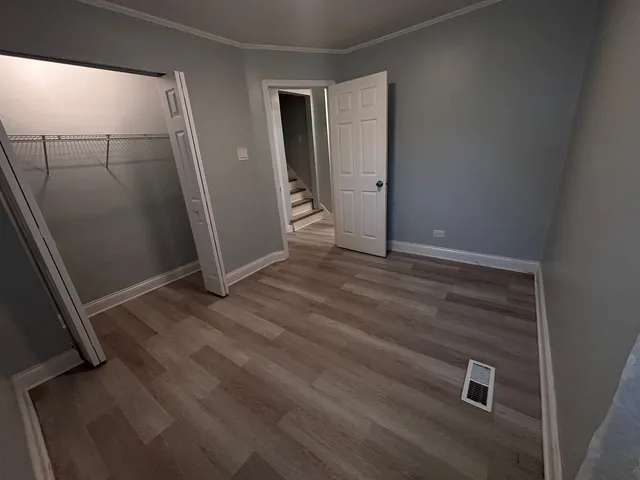 an empty room with wooden floor