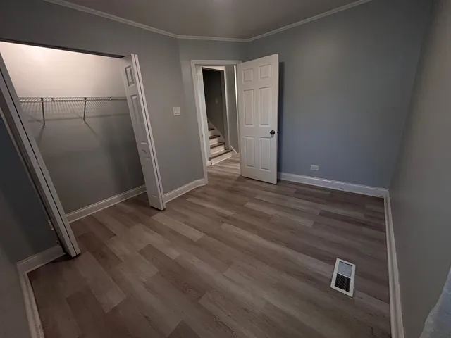 a room with wooden floor and a window