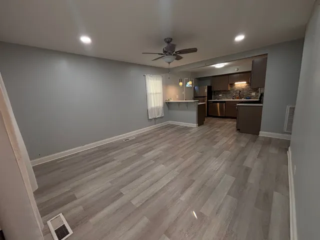 a view of a kitchen with a sink and a refrigerator