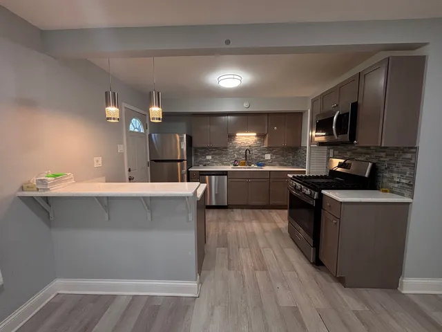 a kitchen with a sink cabinets and stainless steel appliances