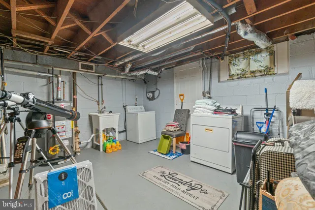 a utility room with dryer washer and other items