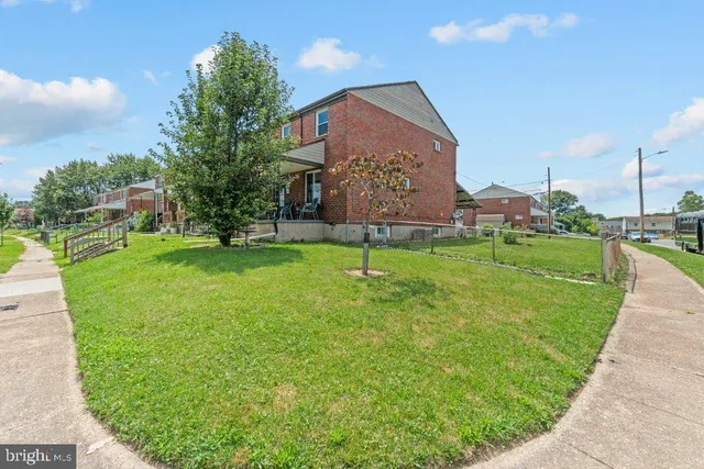a large building with a big yard and a fountain
