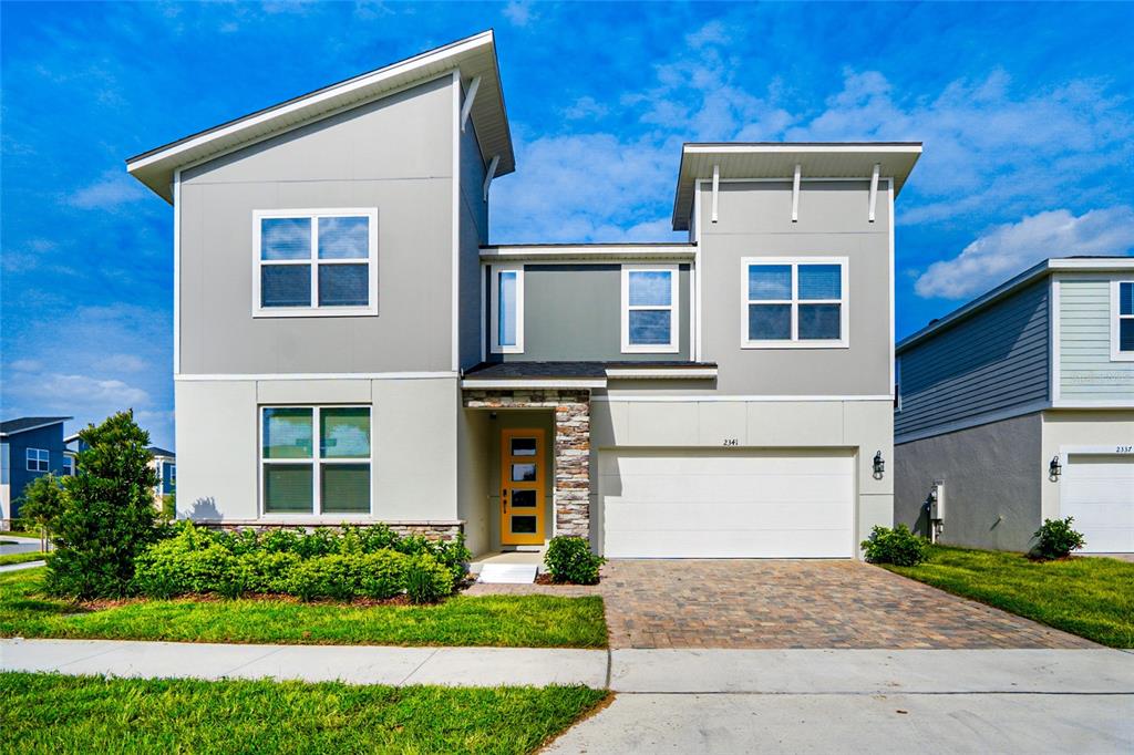 2341 Salty Winds Way Kissimmee, FL 34747 - Photo 1 of 79 a front view of a house with garden