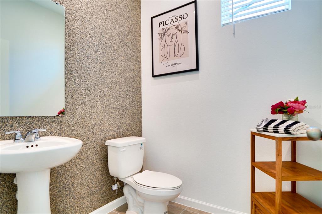 2341 Salty Winds Way Kissimmee, FL 34747 - Photo 19 of 79 a bathroom with a toilet sink and mirror