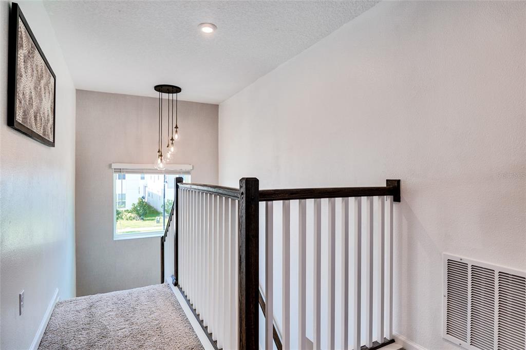2341 Salty Winds Way Kissimmee, FL 34747 - Photo 29 of 79 a view of hallway with window and wooden floor