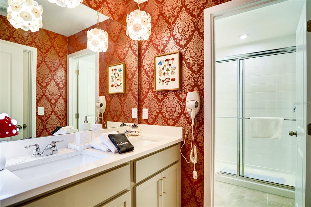 2341 Salty Winds Way Kissimmee, FL 34747 - Photo 44 of 79 a bathroom with a sink and a mirror
