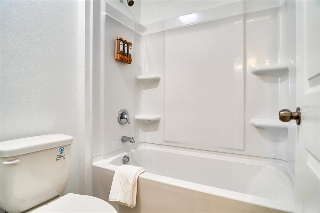 2341 Salty Winds Way Kissimmee, FL 34747 - Photo 50 of 79 a bathroom with a toilet and a bath tub