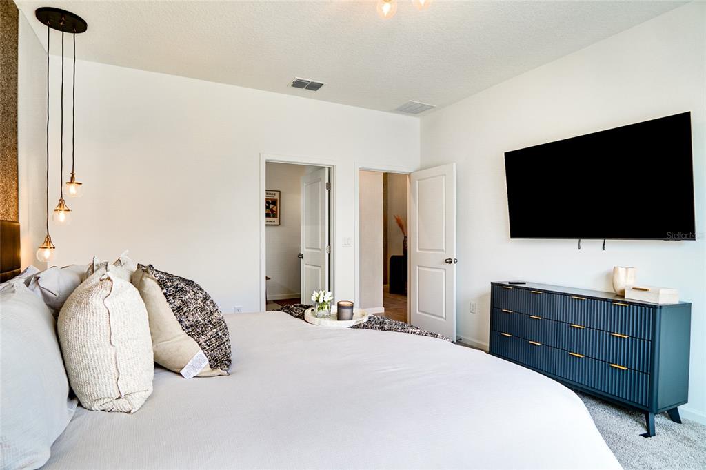 2341 Salty Winds Way Kissimmee, FL 34747 - Photo 5 of 79 a bedroom with a bed and a flat screen tv