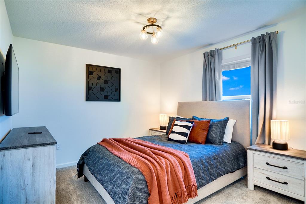 2341 Salty Winds Way Kissimmee, FL 34747 - Photo 51 of 79 a bedroom with bed and window