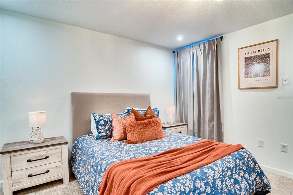 2341 Salty Winds Way Kissimmee, FL 34747 - Photo 53 of 79 a bedroom with a bed and a night stand