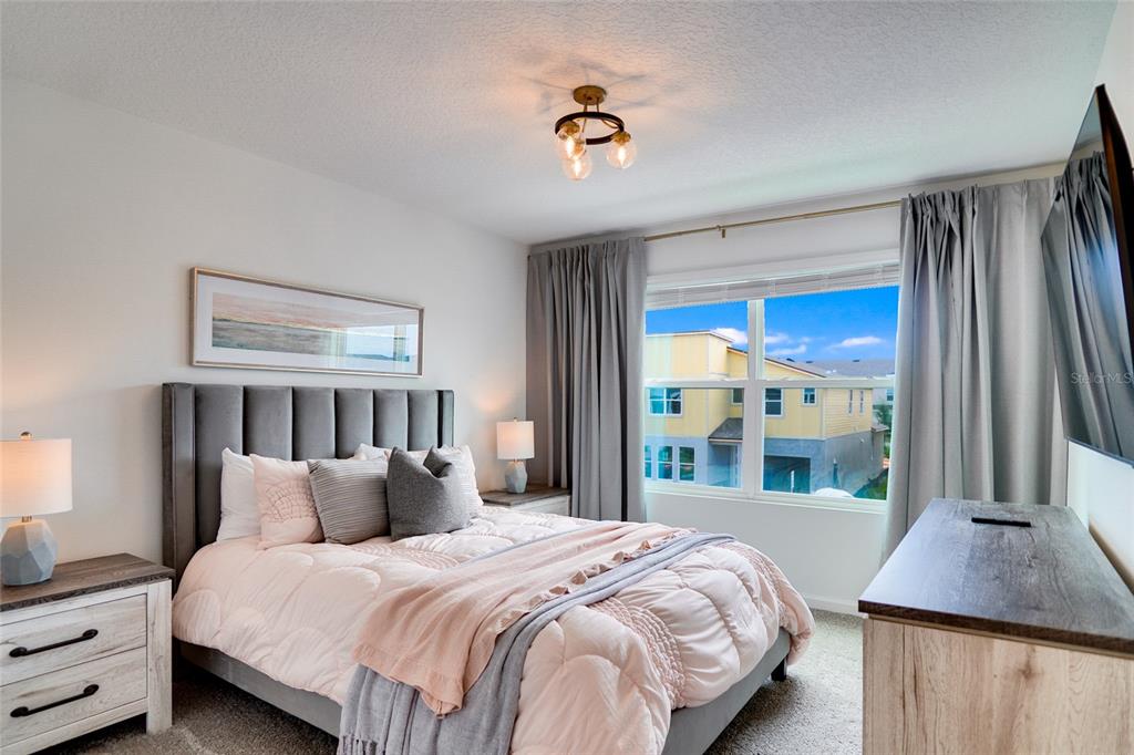 2341 Salty Winds Way Kissimmee, FL 34747 - Photo 54 of 79 a bedroom with a large bed and a window