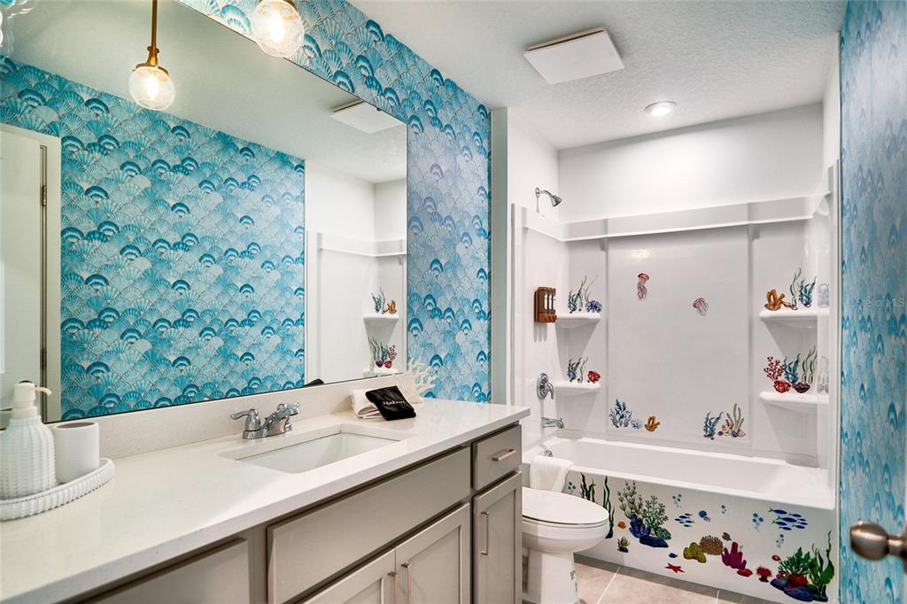 2341 Salty Winds Way Kissimmee, FL 34747 - Photo 57 of 79 a bathroom with a sink a toilet and a shower curtain