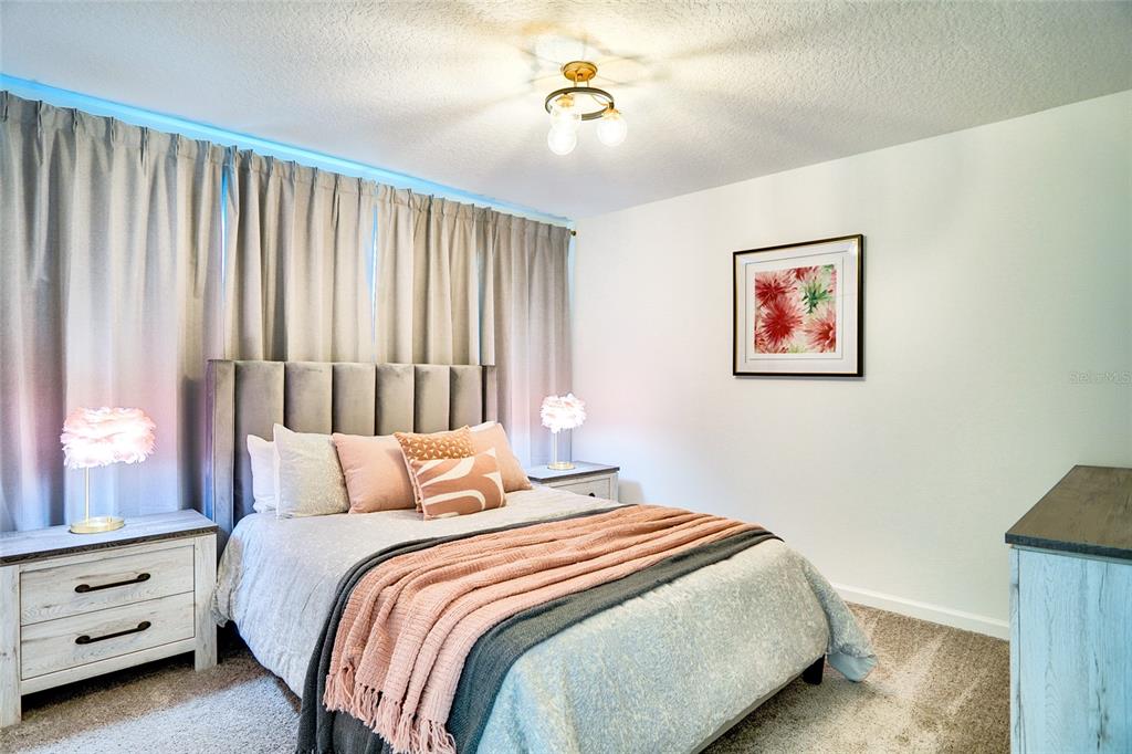 2341 Salty Winds Way Kissimmee, FL 34747 - Photo 65 of 79 a bedroom with a bed and a painting on the wall