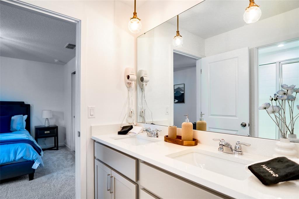 2341 Salty Winds Way Kissimmee, FL 34747 - Photo 66 of 79 a bathroom with a sink and a mirror