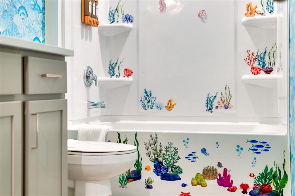 2341 Salty Winds Way Kissimmee, FL 34747 - Photo 68 of 79 a bathroom with a sink a toilet and a shower curtain