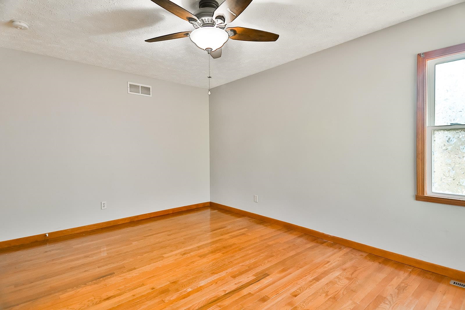 515 Pembroke Road Southwest Poplar Grove, IL 61065 - Photo 18 of 24 an empty room with a window and a fan