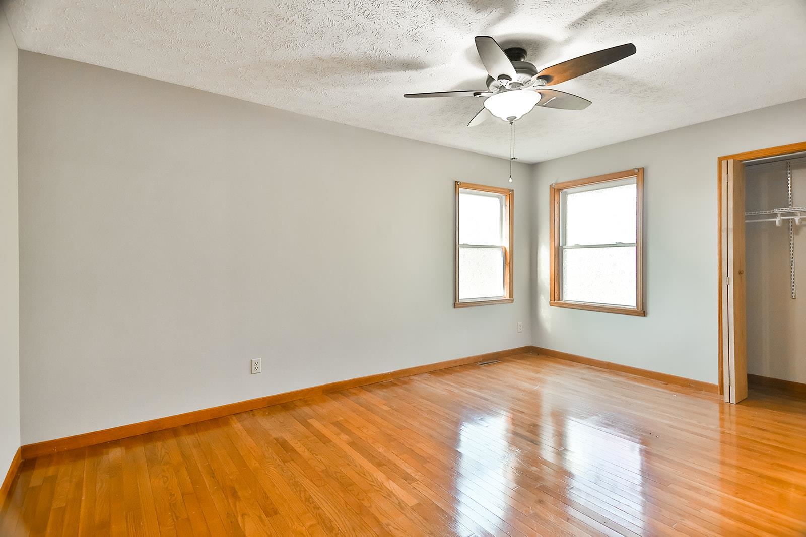 515 Pembroke Road Southwest Poplar Grove, IL 61065 - Photo 19 of 24 a view of a big room with windows and chandelier fan